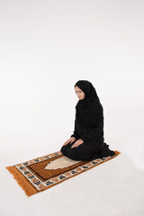 Muslim woman praying on white Background