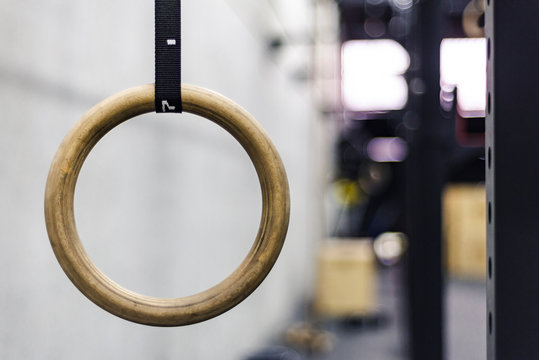 Gymnastic ring hanging in gym on blurred background