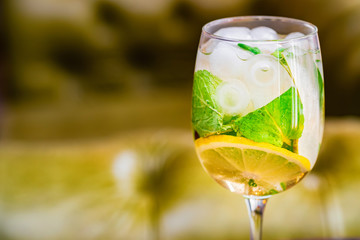 Glass with delicious fresh homemade mojito on blurred background