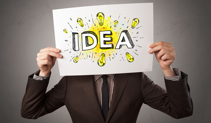 Young person holding white paper with new idea concept in front of his head

