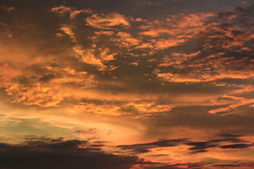 Vivid dramatic twilight sunset sky with colorful clouds and silhouettes of birds