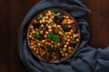 Chickpeas with fried eggplants, garlic, zira and paprika. Eastern cuisine., top view.