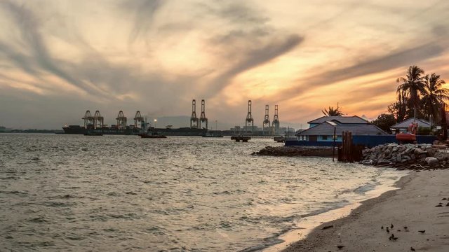 Timelapse shot of Sunrise at the beach beside Padang Kota Lama, ferry traffic as background, George Town, Penang, Malaysia.
