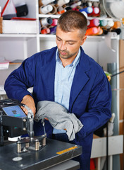 male worker makes print on shirt