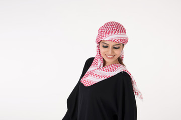 pretty young Arab female in traditional dress posing on white background