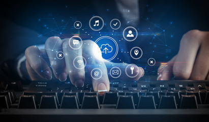 Business woman woman typing on keyboard with application icons around
