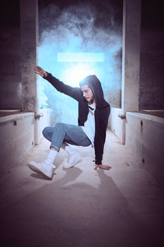 Trendy guy dancing in smoke