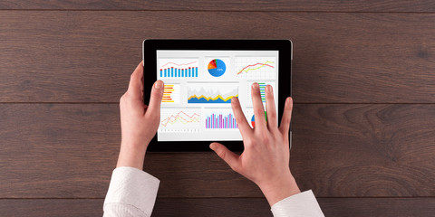Hand making diagrams and charts on tablet