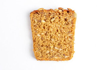 Slice of multigrain bread with sunflower and pumpkin seeds and flax seed on a white background