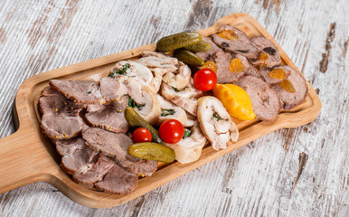 Assorted meat appetizer, cow's tongue, ham, stuffed chicken roll, meat roll with pepper, greens on...