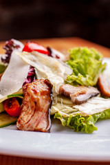 Salad with smoked catfish, carrots and miso dressing.The work of a professional chef. Dish from a restaurant Close-up.