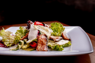 Salad with smoked catfish, carrots and miso dressing.The work of a professional chef. Dish from a restaurant Close-up.