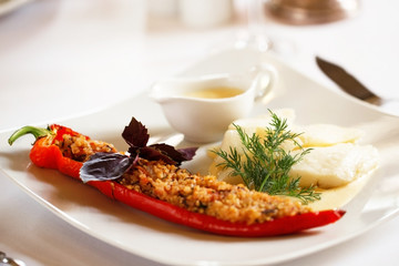 Baked fish with stuffed pepper and sauce 