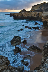 Fototapeta premium Idyllic sea, rocks and cliffs scenery in Aveiros Beach. Albufeira, Algarve, Portugal