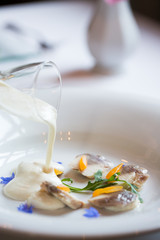 Obraz na płótnie Canvas cream soup with mushrooms pours into the plate