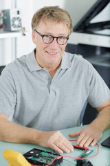 senior man assembling a desktop computer