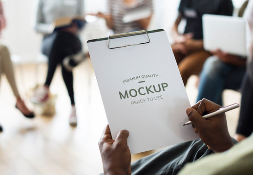 Person Holding Clipboard in Meeting Mockup