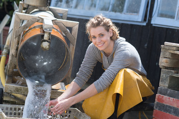 happy female worker washing oysters