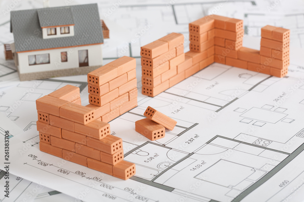 Wall mural model house construction with brick on blueprint