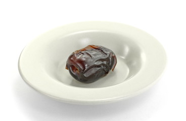 Dried dates in a plate. Dried dates isolated on white background.