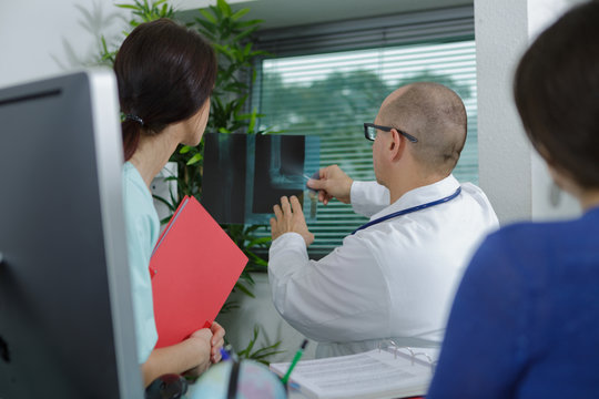 medicine doctor showing x-ray to his female colleague