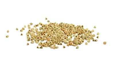 Pile of buckwheat grain isolated on white background close up. Ancooked buckwheat.