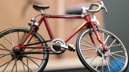 Fototapeta na wymiar toy steel bicycle standing in front of a workshop 