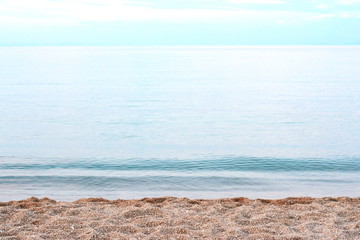 Fototapeta na wymiar Beautiful soft waves of Blue Ocean with Sandy Beach Background close up. Sea sand wallpaper