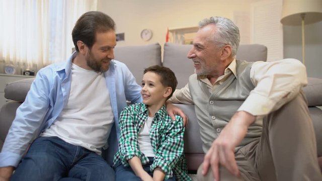 Grandpa and dad sharing experience with preteen boy, family bounds, togetherness