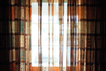 Bright window with colorful drape, moody atmosphere