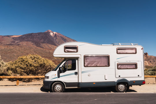 mobile house parked on asphalt route near picturesque view of blue heaven and mountain Teide in Tenerife, Canary Islands, Spain
