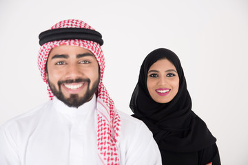 arab couple smiling and standing on white background