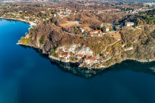 Aerial view of Hermitage of Santa Caterina del Sasso, clinging to a rock face directly overhanging the lake Maggiore, Leggiuno, Italy
