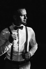 stylish guy in a white shirt with bow tie and suspenders. guy lo