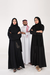 Two arab females with one male smiling and standing on white background