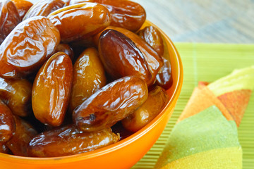 sweet algerian arabic dates fruits on an orange plate