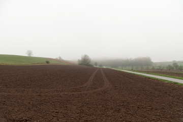 Traktorreifenspuren auf dem gepflügten Acker