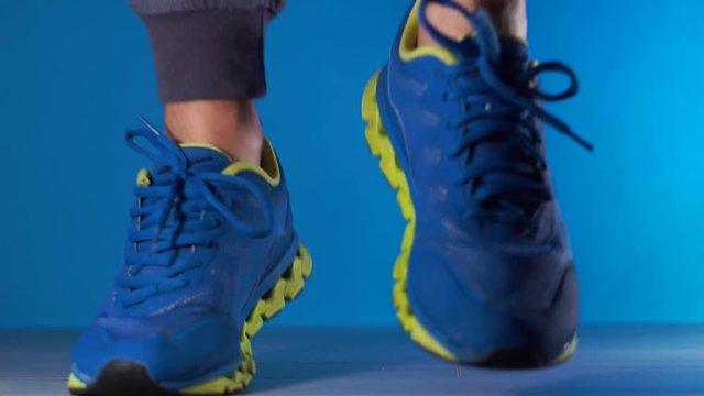 cropped shot of young african american sportsman in sneakers jumping