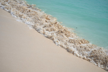 wave crashing alon the shore on the island of barbuda