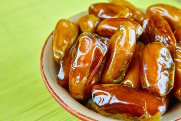 Sweet arabic algerian dates fruits on a ceramic plate