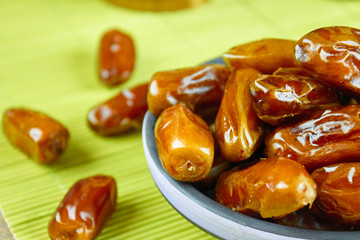 Sweet arabic algerian dates fruits on a ceramic plate