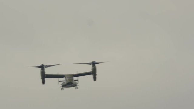 Boeing V-22 Osprey helicopter flies over the beautiful ocean coast.  Summer, daytime, wide shot, pan. 4K/ 10bit/ ProRes 422HQ/ BT.2020