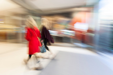 Blurred mall, people rushing through corridor, zoom effect