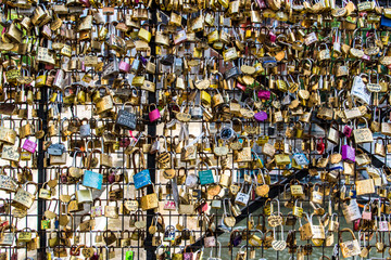 Love locks from a bridge in Paris, France. It is a tradition for a couple to place a lock on a...