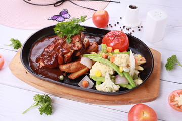 Grilled chicken Tabaka with sauce on stone plate. 