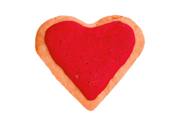 Fototapeta na wymiar Sweet gingerbread home made cookie shaped as heart with red glaze on it isolated at white background. Valentine's day bakery.