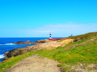 Fototapeta na wymiar View of the coast and the lighthouse of Illa Pancha in Ribadeo, Lugo, Galicia - Spain