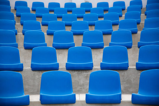Tennis Court, empty blue seats.