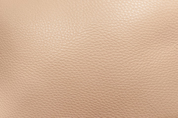 Texture of beige genuine leather as a background