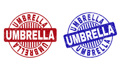 Grunge UMBRELLA round stamp seals isolated on a white background. Round seals with distress texture in red and blue colors. Vector rubber overlay of UMBRELLA label inside circle form with stripes.